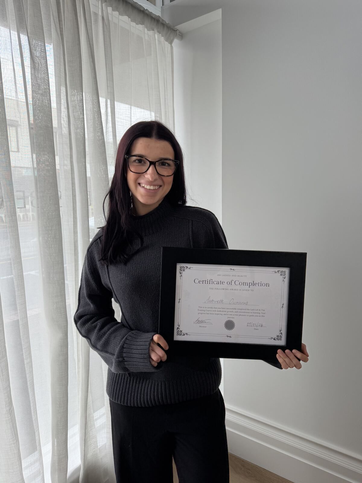 Antoinette Ouzounis with her Lash Lift and Tint Certificate of Completion